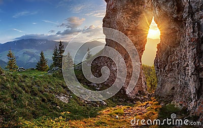 Sun in rock window at sunset landscape Stock Photo