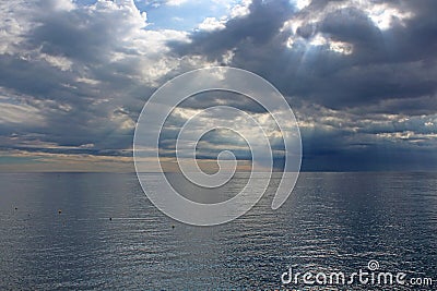 Sun's rays passing through the storm clouds Stock Photo