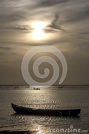 The sun sets over a boat moored in Jaffna Lagoon in the far north of Sri Lanka. Editorial Stock Photo