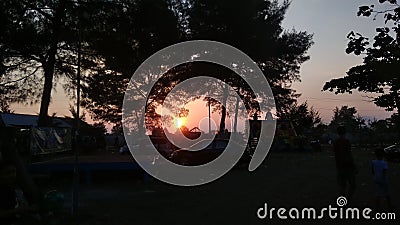 the sun sets in the west. surrounded by trees exposed to light bias Stock Photo