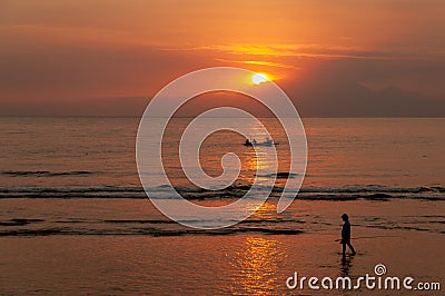 Sun setting over Indonesian fishermen - looking from Lombok towards Bali Stock Photo