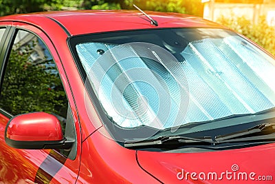 Sun shade under windshield in car, closeup. Heat protection Stock Photo