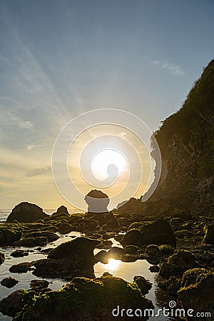 Sunrise in wild rocky beach stock photo Stock Photo