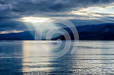 Sun shining through thick cloudy sky, silver lining Stock Photo