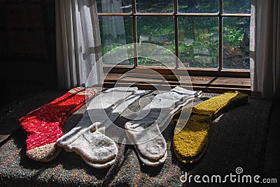 Sun shining through a window on hand knit woolen stockings Stock Photo