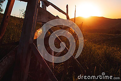 The sun is stunning sunset over the mountains of the Altai. fence. Meadows Stock Photo