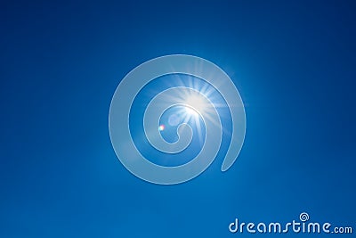 Sun, sunbeams against blue sky - cloudless heaven. Photography with Lense flair effect Stock Photo