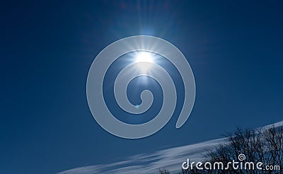 Sun and sunbeams in the blue sky Stock Photo