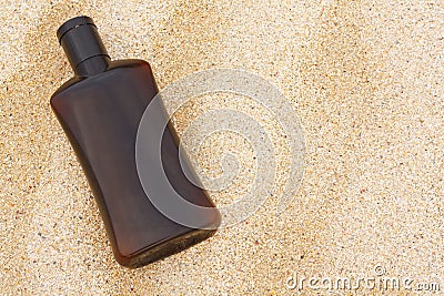 Sun tan oil on sand Stock Photo