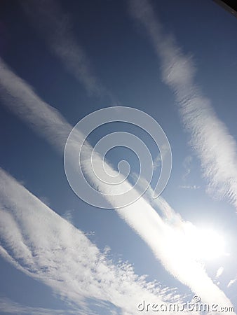 Sun with thin white clouds in autumn blue sky Stock Photo