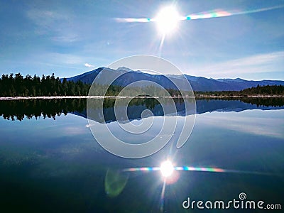 Sun in the water of the taiga lake Stock Photo