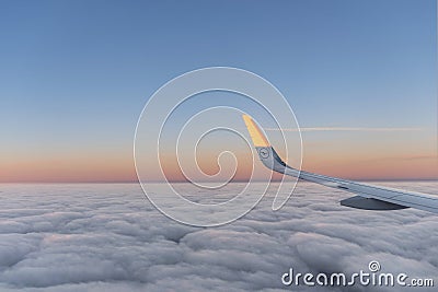 Sun at the wing of an aircraft flying in sunrise Editorial Stock Photo