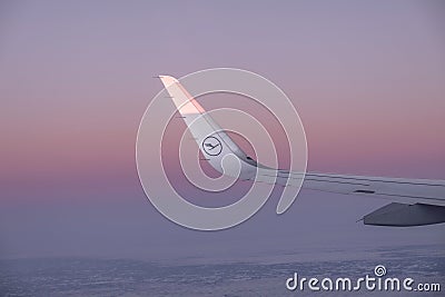 Sun at the wing of an aircraft flying in sunrise Editorial Stock Photo