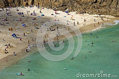 Sunbathers and swimmers on Porthcurno beach Editorial Stock Photo