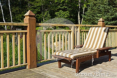 Sunbathing chair on a wooden deck Stock Photo