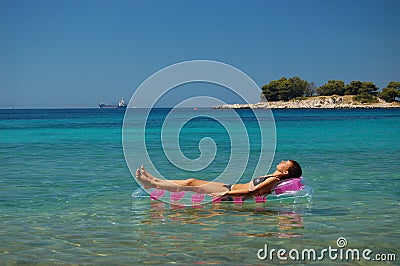 Gorgeous scenic view of young girl sunbathing on A Stock Photo