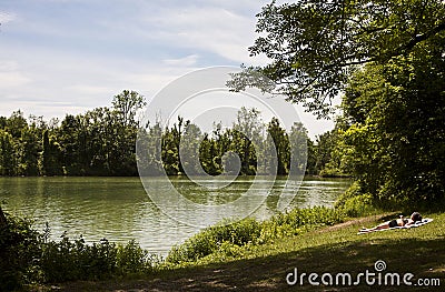 Sunbathing at Poschinger Weiher lake near Munich Editorial Stock Photo