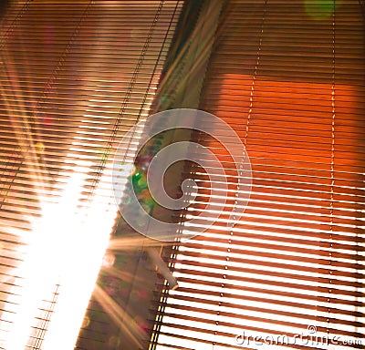 Sunbeams through half-open jalousies Stock Photo