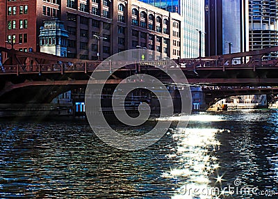 Sunbeams extend over the downtown Chicago Loop, creating glittering stars on the river during morning Stock Photo