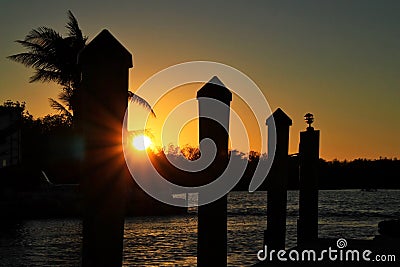 Sunbeams extend over treelined background in Marathon Key bay Stock Photo