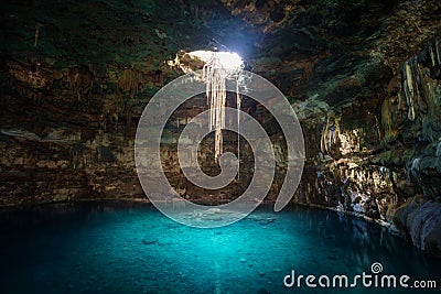 Sunbeams penetrating in opening of Blue cenote Stock Photo