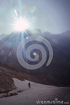 Sunbeams and traveler silhouette in Himalayan mountains. Stock Photo