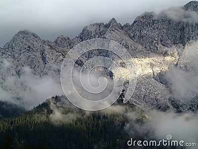 Sunbeam and clouds at mountain massif Stock Photo