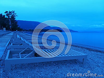 Sunbeds on the beach at the bluehour, background Stock Photo