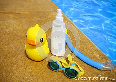 Suncream, snorkel, goggles and yellow rubber duck Stock Photo