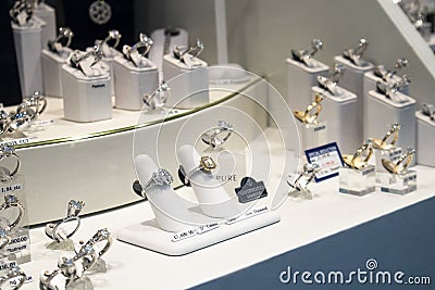 Beautiful Platinum and Gold Diamond rings on display in Jewelry Shop Window Editorial Stock Photo