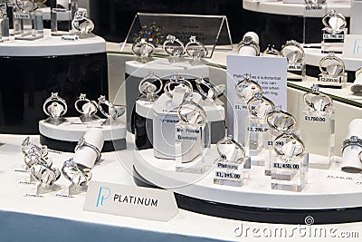 Beautiful Platinum and Gold Diamond rings on display in Jewelry Shop Window Editorial Stock Photo