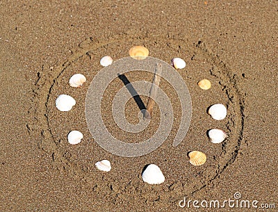 Sundial Made with Seashells on Beach, Close Up Stock Photo