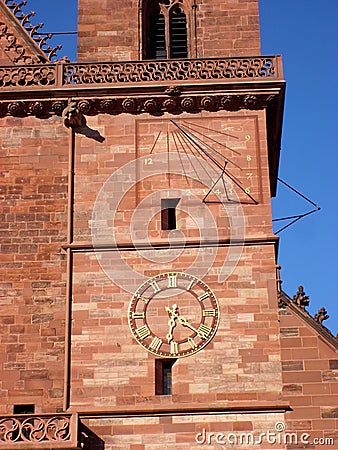 Sundial and mechanic clock on cathedral, Basel, Switzerland Stock Photo