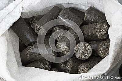 Sunflower shell biomass briquettes in the bag Stock Photo