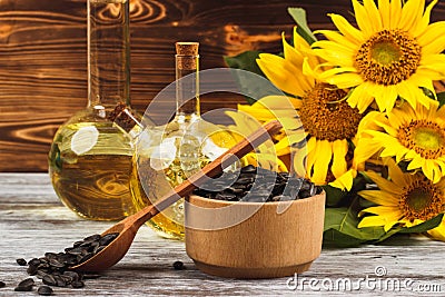 Sunflowers, bottle with oil and sunflower seeds Stock Photo