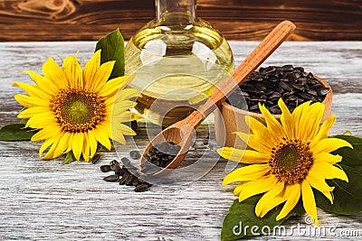 Sunflowers, bottle with oil and sunflower seeds Stock Photo