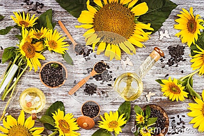 Sunflowers, bottle with oil and sunflower seeds Stock Photo