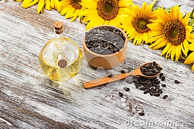 Sunflowers, bottle with oil and sunflower seeds Stock Photo