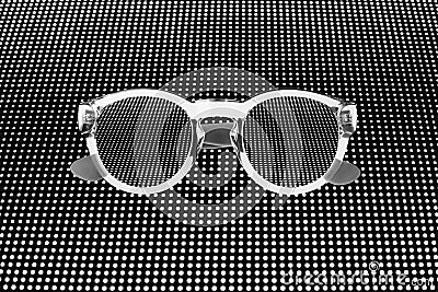 Sunglasses close up, abstract white shiny dots pattern, dark black dotted background, sunglass screen concept, digital display Stock Photo