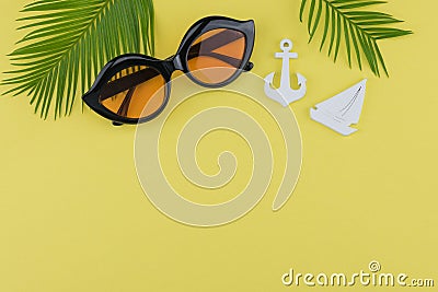 Sunglasses decorate with fern leaves and tiny sailboat and anchor Stock Photo
