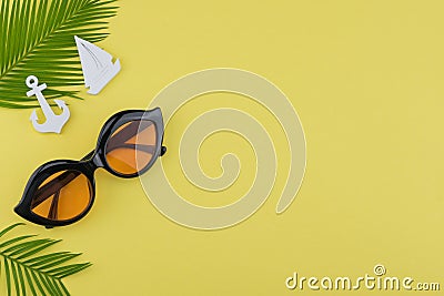 Sunglasses decorate with fern leaves and tiny sailboat and anchor Stock Photo