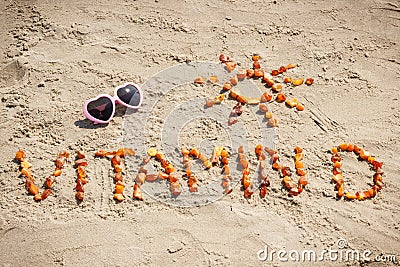 Sunglasses, inscription vitamin D and shape of sun at beach, summer time and healthy lifestyle concept Stock Photo