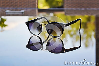 Sunglasses reflection on table Stock Photo