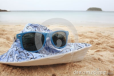 Sunglasses on sandy beach Stock Photo