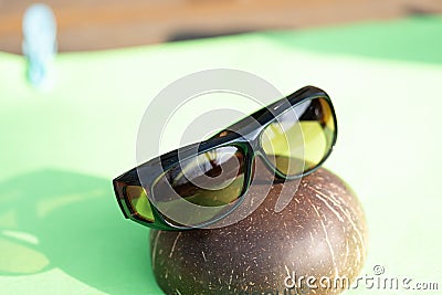 Sunglasses with yellow lenses special for driving. Shoot in a summer day outside closeup Stock Photo