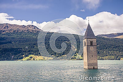 Sunken church tower in lake in the alps Stock Photo