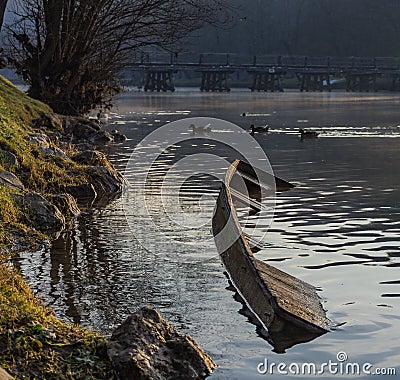 Sunken river boat on the coast of a river Stock Photo