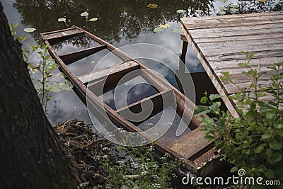 A sunken wooden boat at the pier Stock Photo