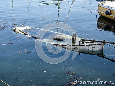 Sunken Wooden Boat in tidal harbour Stock Photo