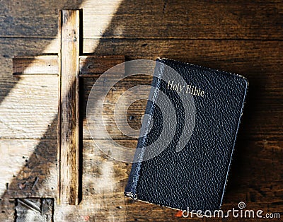 Sunlight on a Bible and wooden cross Stock Photo